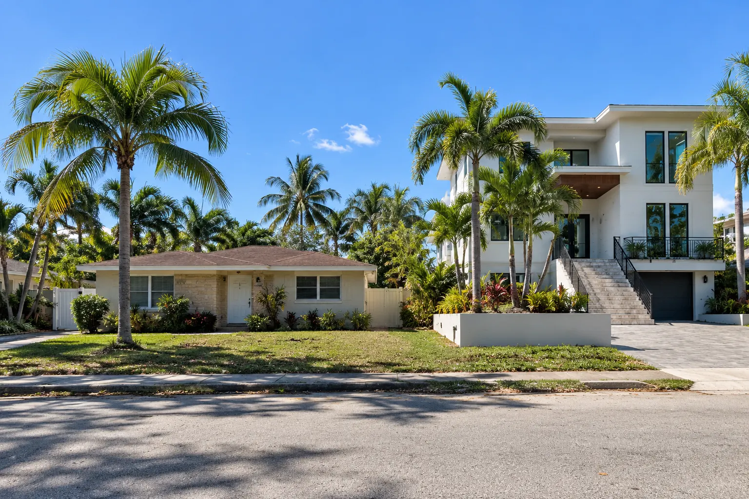 Older low house next to a new elevated home in Miami Beach